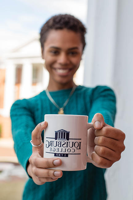 Student holding a Louisburg College mug